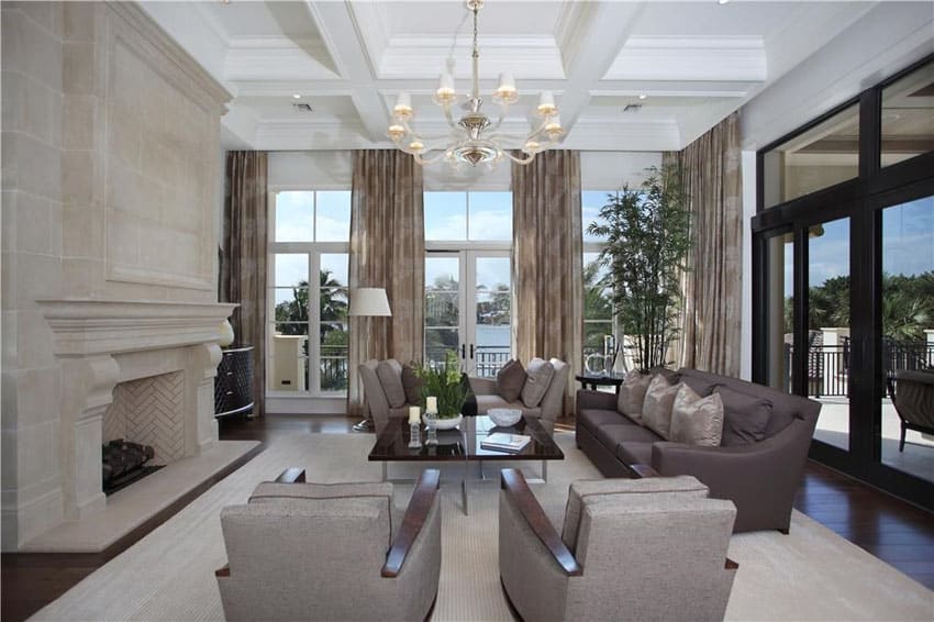 Room with corner layout with fireplace and chandelier