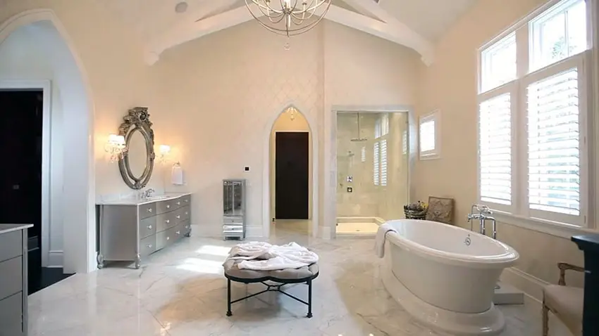 Luxury master bathroom with marble tile and oval bathtub