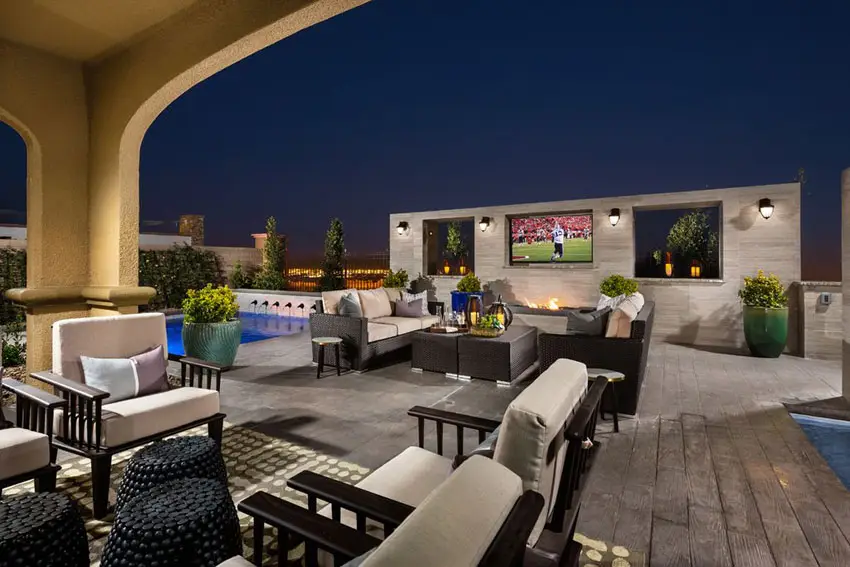 Patio with outdoor television and rattan chairs