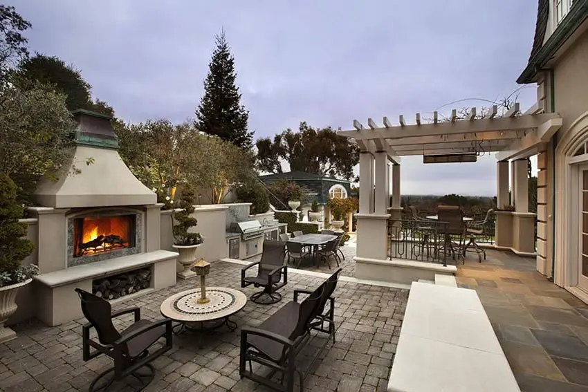 Luxury paver patio with outdoor fireplace and pergola