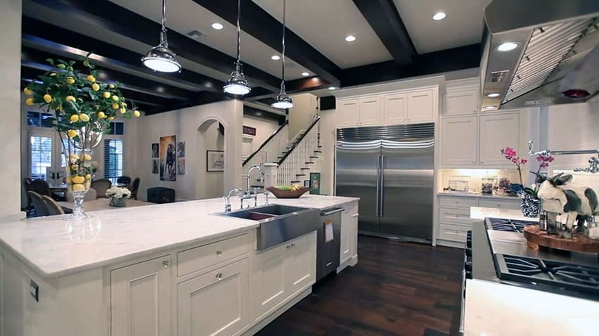Luxury white shaker cabinet kitchen with open beams and chrome pendant lights