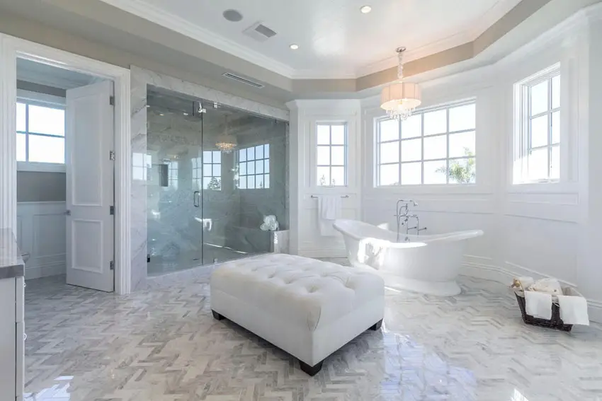 Transitional style bathroom with white ottoman and chevron pattern tiles 