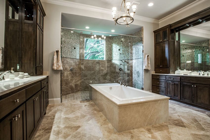 Master bathroom with center bathtub and dark marble wood cabinets with large glass shower