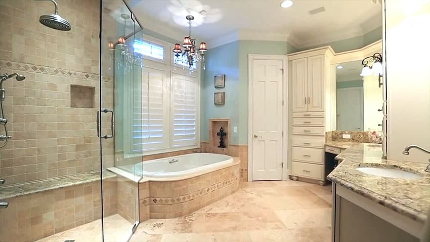 Master bathroom with limestone tile rainfall shower and bathtub surround