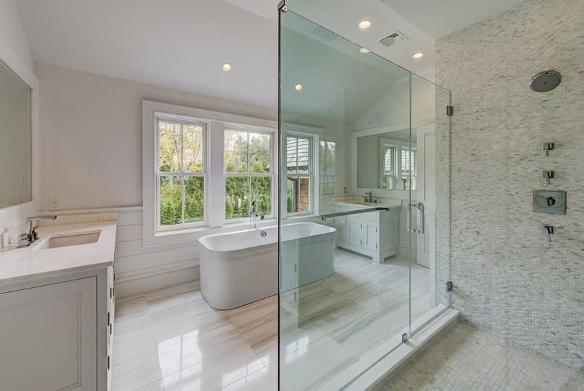 Master bathroom with marble floors and tile shower