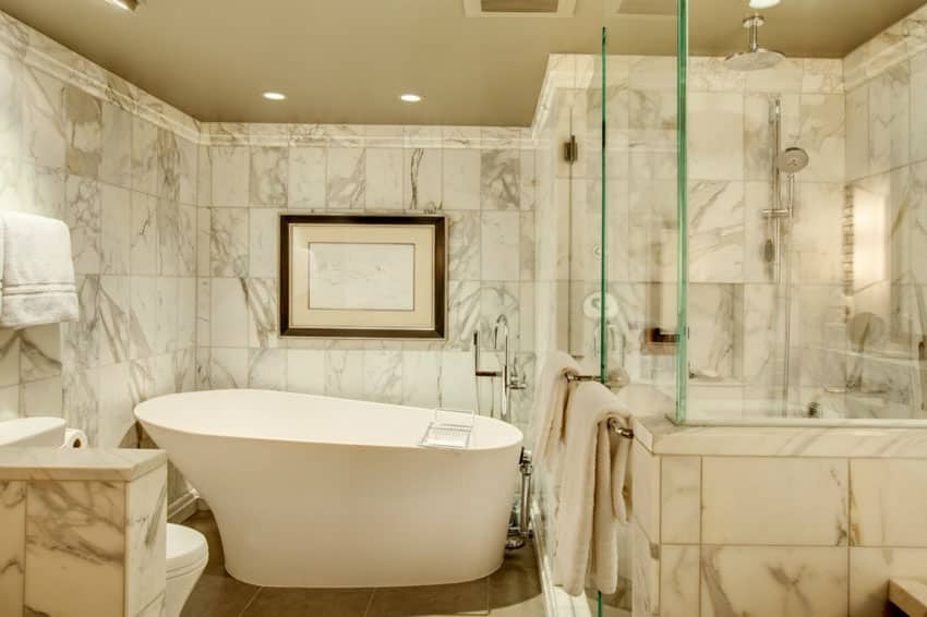 master bathroom with polished marble shower and soaking bathtub