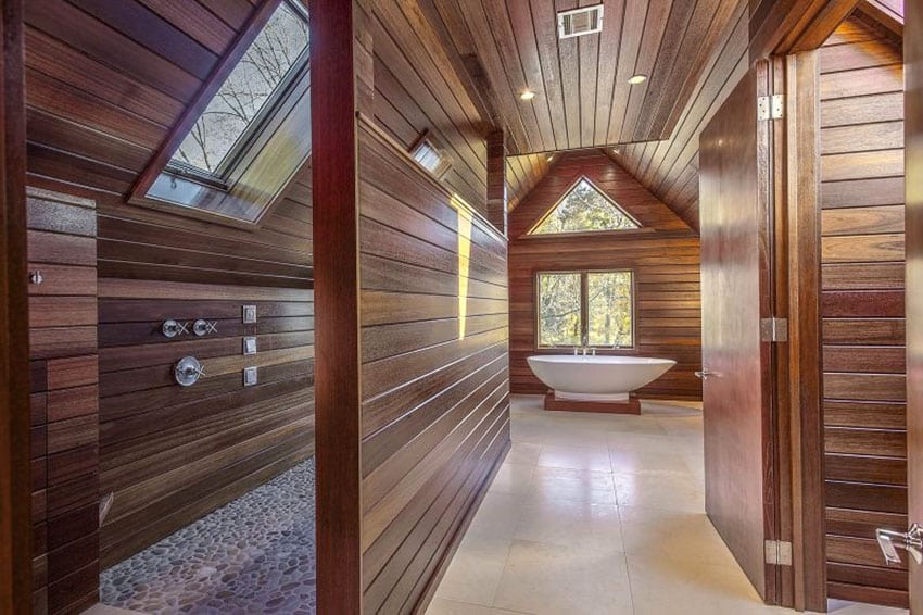 Master bathroom with wood siding, pebble floor shower and freestanding tub