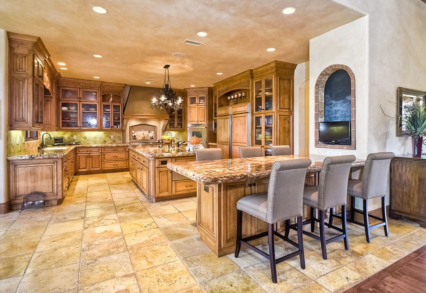 Mediterranean kitchen with u shaped design and large breakfast bar dining area