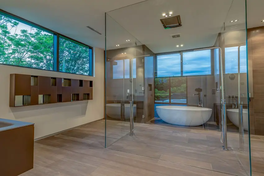Floors in walnut finish and wall in wood laminates with wall-hung shelves with tub and shower