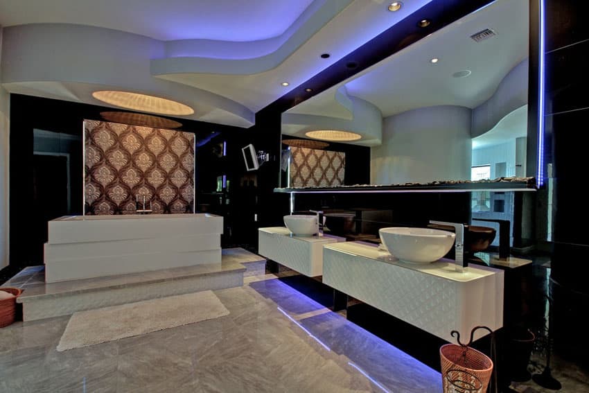 Modern bathroom with quartz floors, neon mirror and vanity lighting