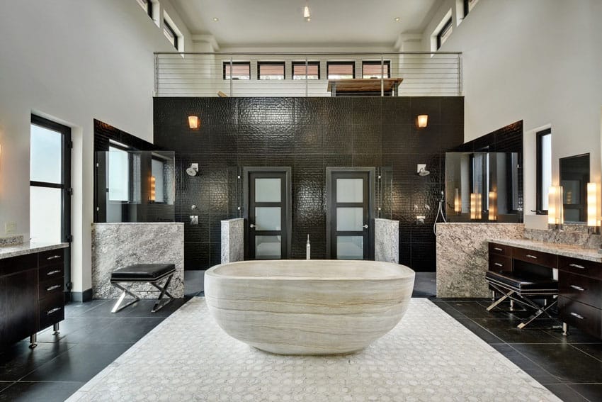 Modern bathroom with custom sandstone bathtub and dual marble vanities