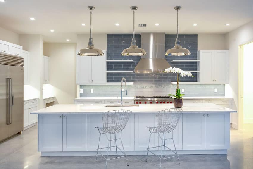 Kitchen with polished concrete floors and blue subway tiles for backsplash