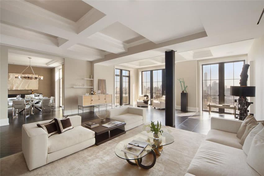 Modern living room with white furniture herringbone style wood floors and city views