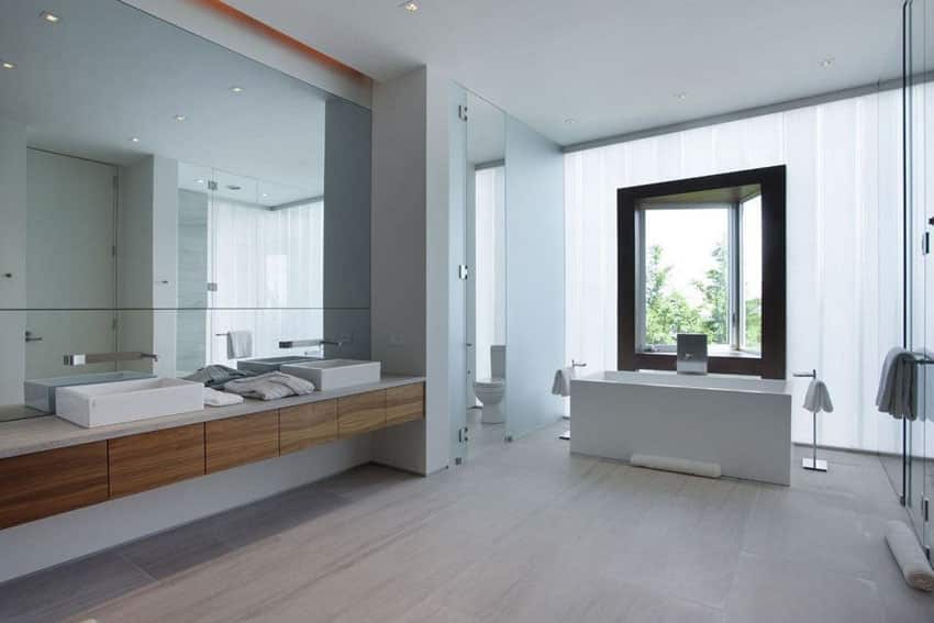 Modern master bathroom with skirted straight edge bathtub and floating vanity