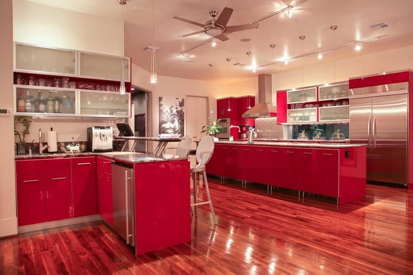 Kitchen with red cabinets, ceiling fan and wine cooler