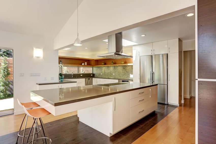 White kitchen with steel countertops and faux wood flooring
