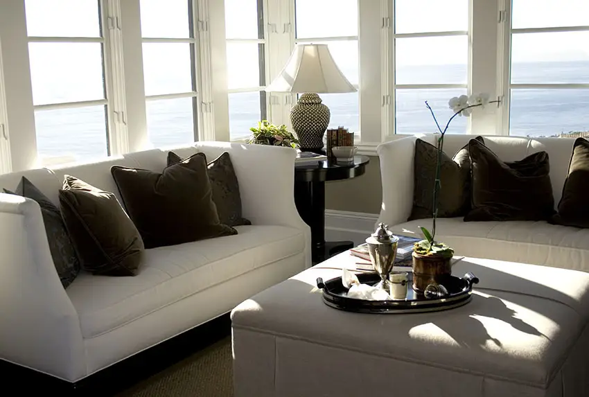 Room with wraparound windows and black side table