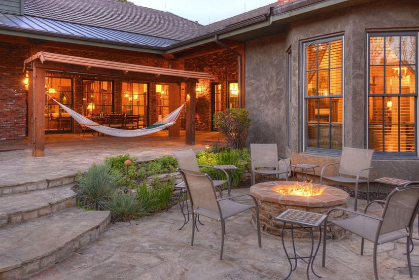 Patio with fire pit and wood canopy with hammock