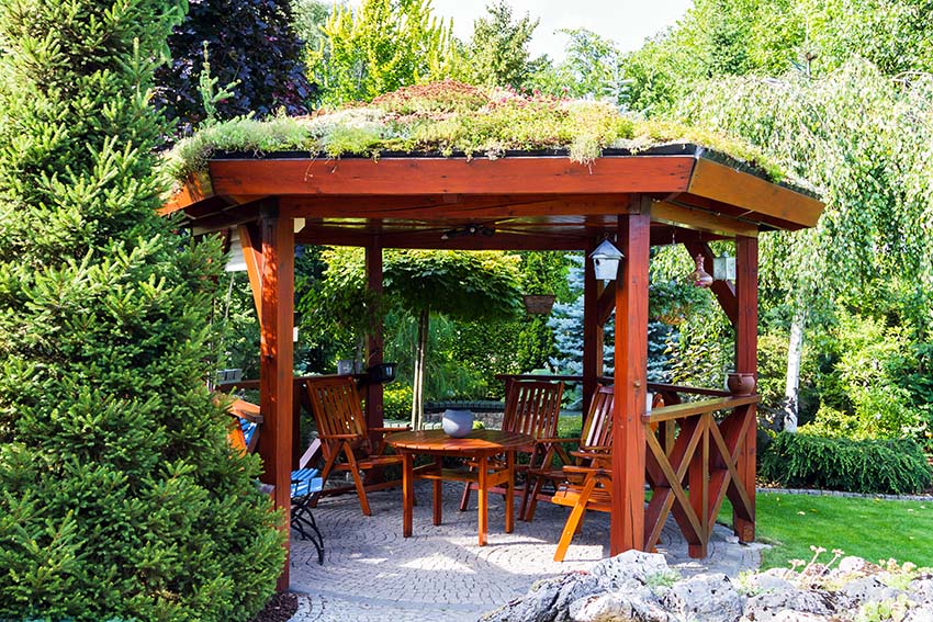 Pavilion gazebo with green roof and wood seating