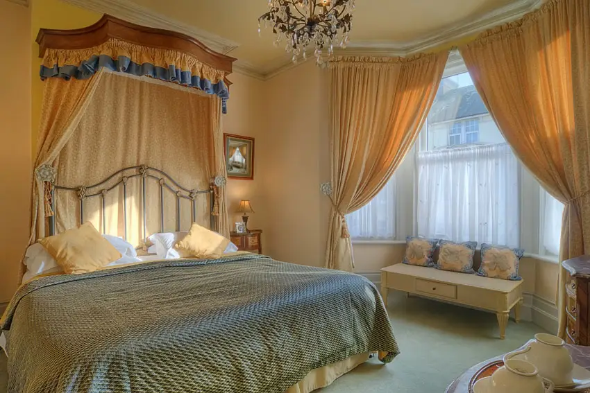 Pretty bedroom design with flowing curtains and glass chandelier