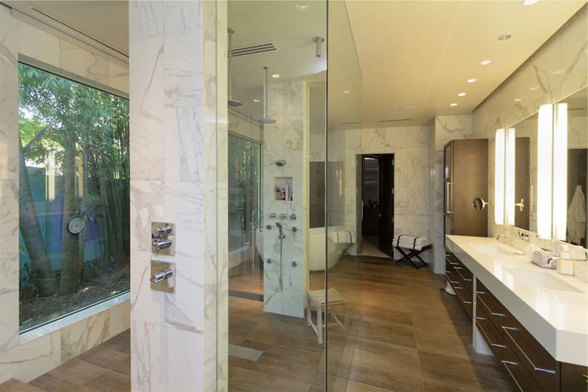 Rain shower with large picture window and marble walls