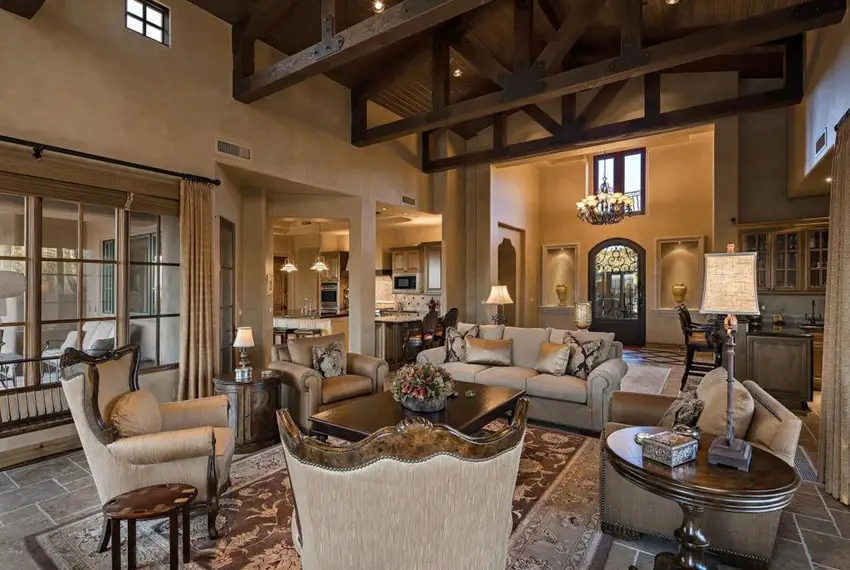 Room with high vaulted ceiling and exposed roof trsses and English couches