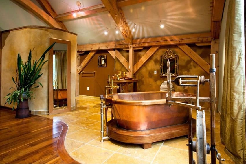 Rustic master bathroom with large copper bathtub and high ceiling with exposed wood beams