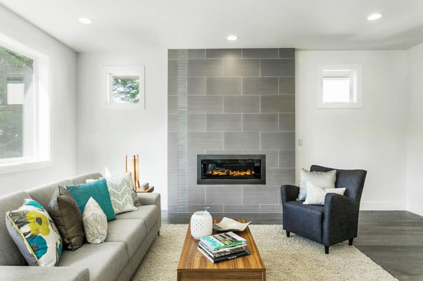 Stylish room with grey tile fireplace and engineered hardwood dark color floors