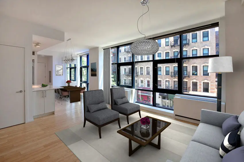 Small apartment living room with hardwood floors and modern chandelier