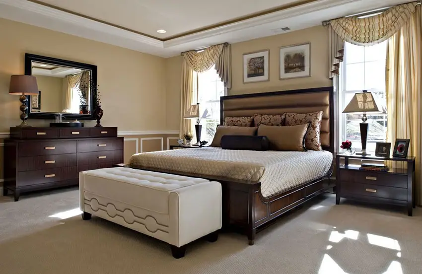 Stylish bedroom with wood drawers, bedside tables, and bed frame 