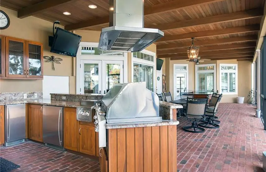 Sunroom kitchen with brick patio