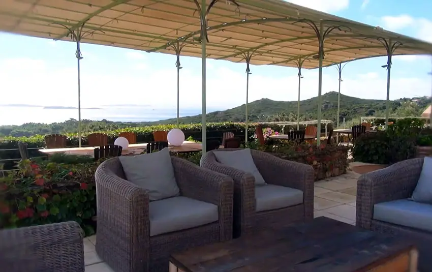 Synthetic rattan chairs on outdoor patio with ocean view
