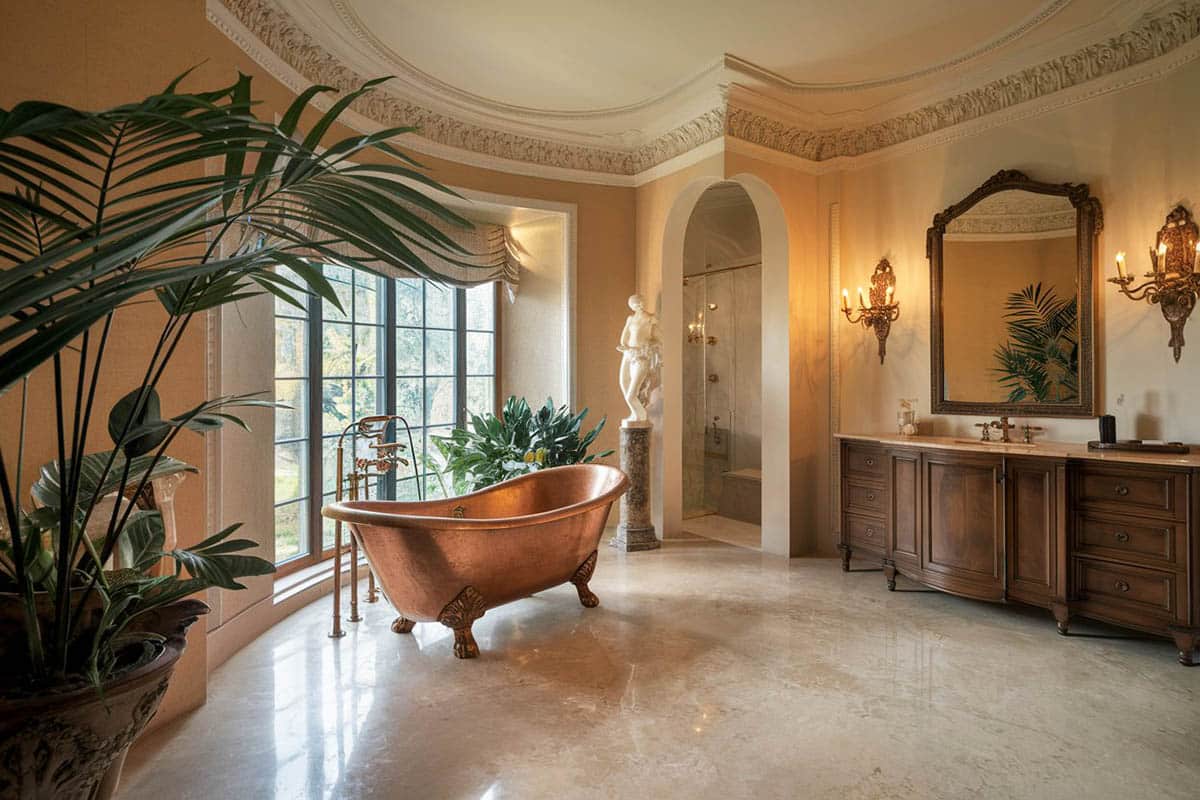 Bathroom with wall sconces, mirror and vanity with marble top