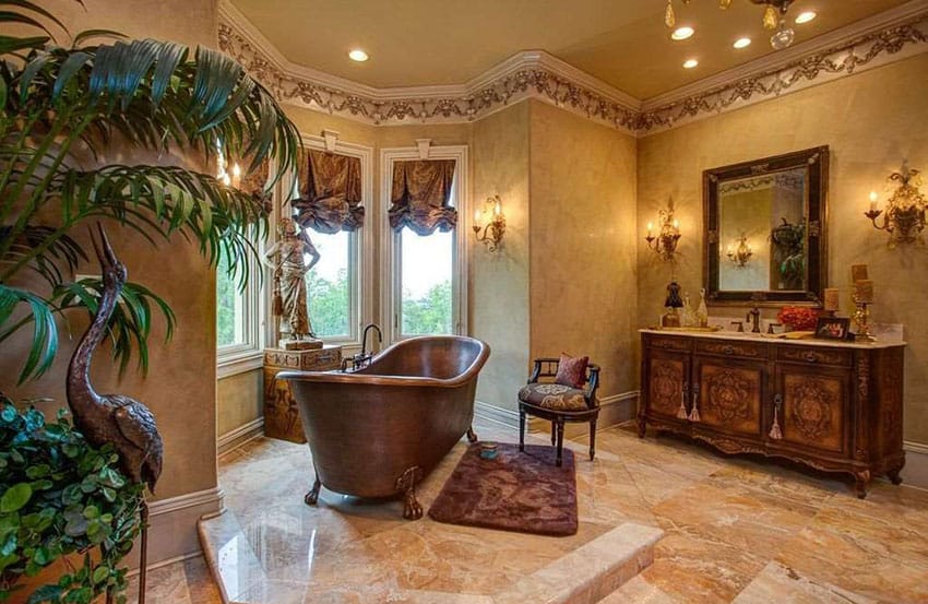 Bathroom with wall sconces, mirror and vanity with marble top