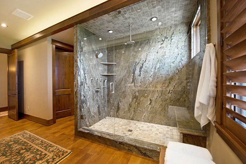 Traditional bathroom with pine wood floor and granite shower with tile floor