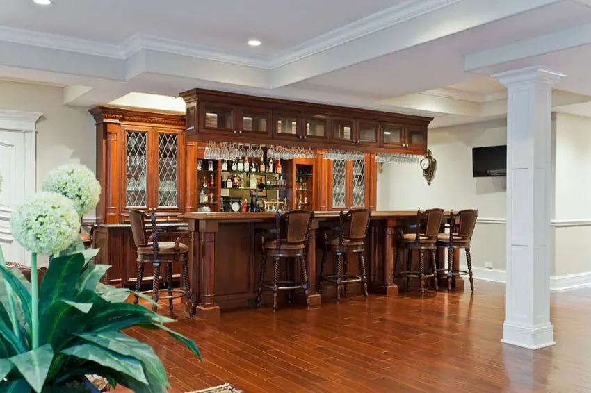 Bar with wooden teak floors set against white walls