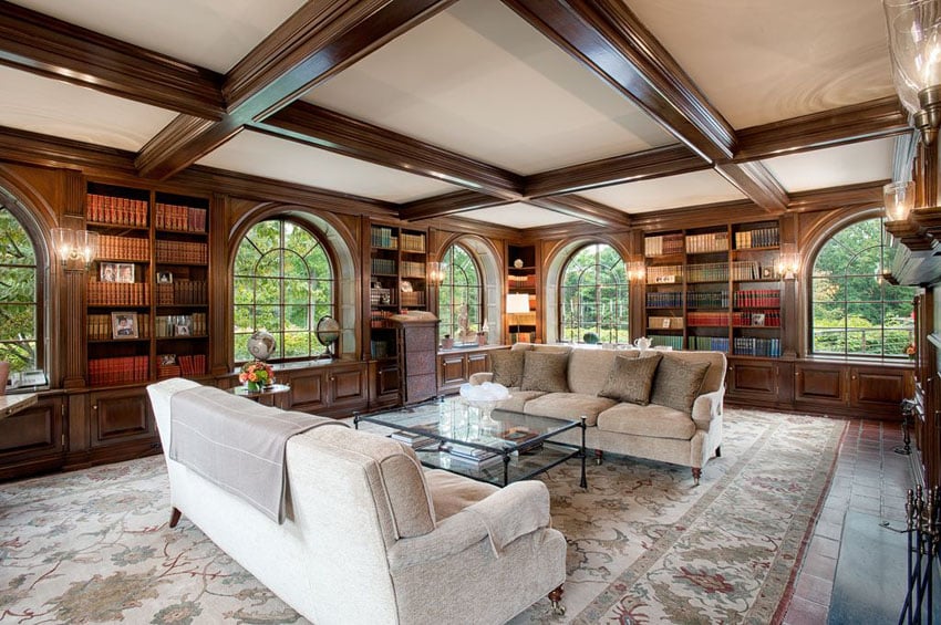 Traditional formal living room with wood built in bookcases and beam ceiling