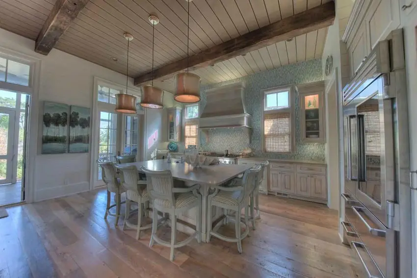 Kitchen with hickory floors, beadboard ceiling and distressed wood type cabinets