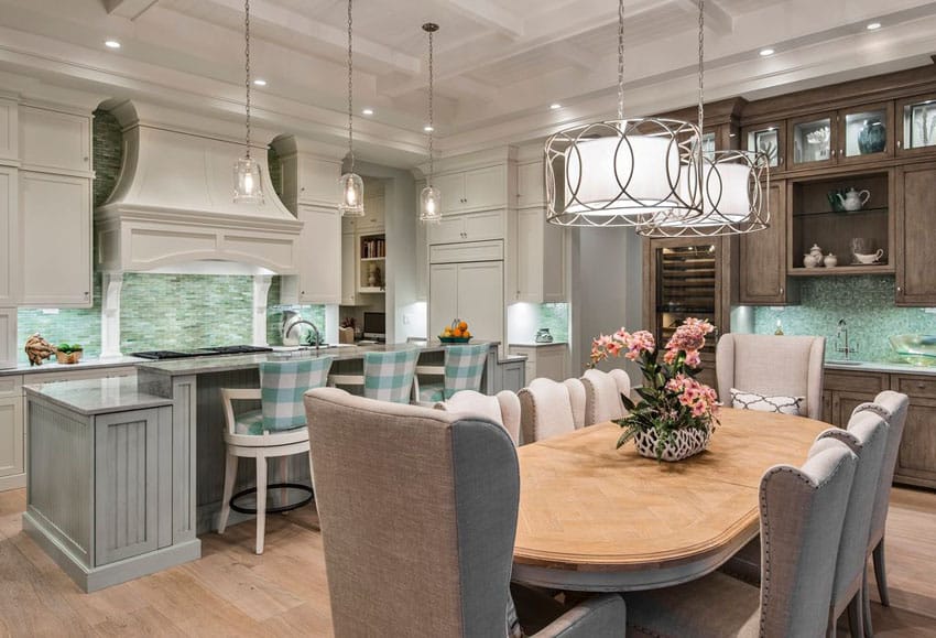 Kitchen with beadboard cabinets, inset paneled cabinets and sea green chairs