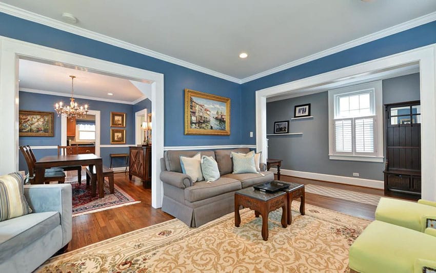 traditional living room with crown molding and blue walls