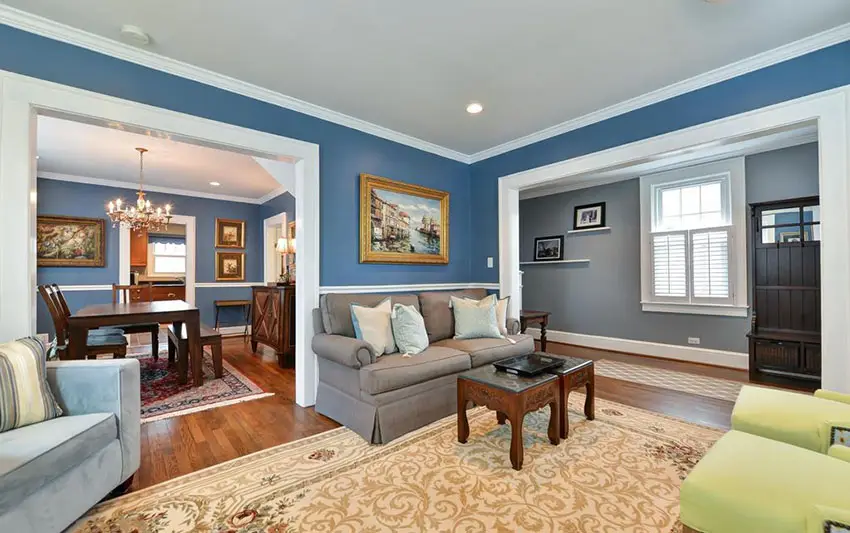 Traditional living room with crown molding and blue walls