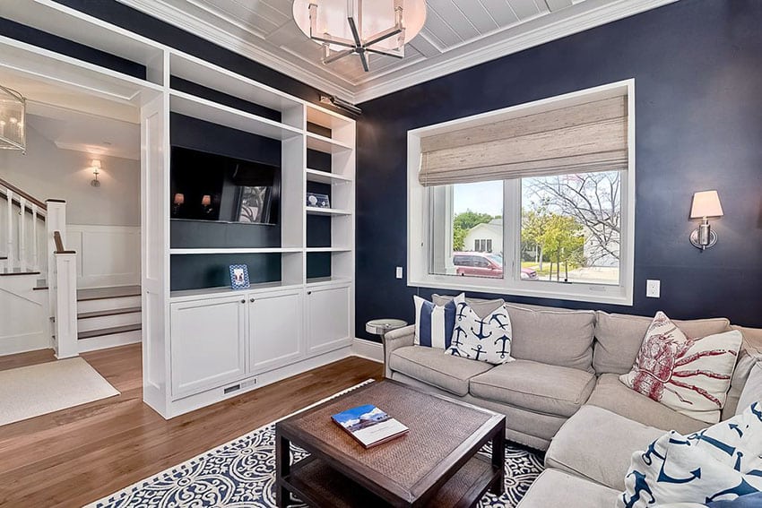 Traditional living room with dark walls and white built in bookshelf's