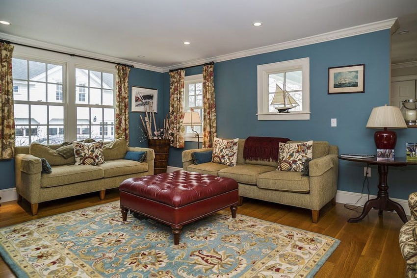 Traditional living room with navy walls and hardwood floors