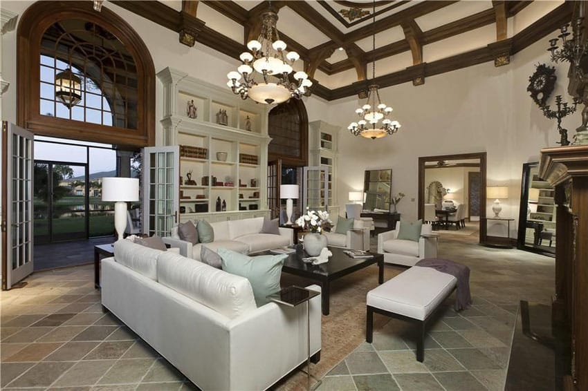 Room with slate floor tiles and dual chandeliers