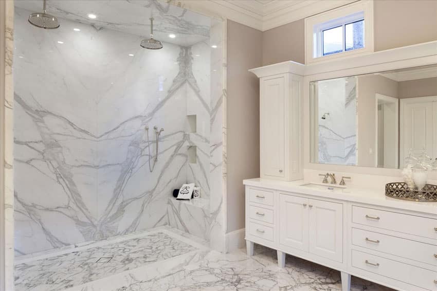 Traditional master bathroom with dual showerhead rainfall shower and white marble