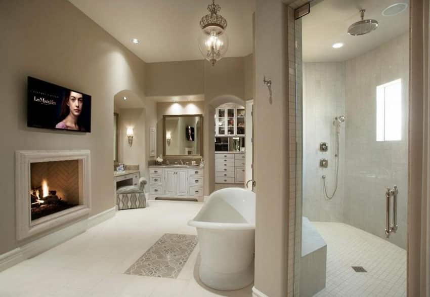 Traditional master bathroom with fireplace walk in shower and makeup counter