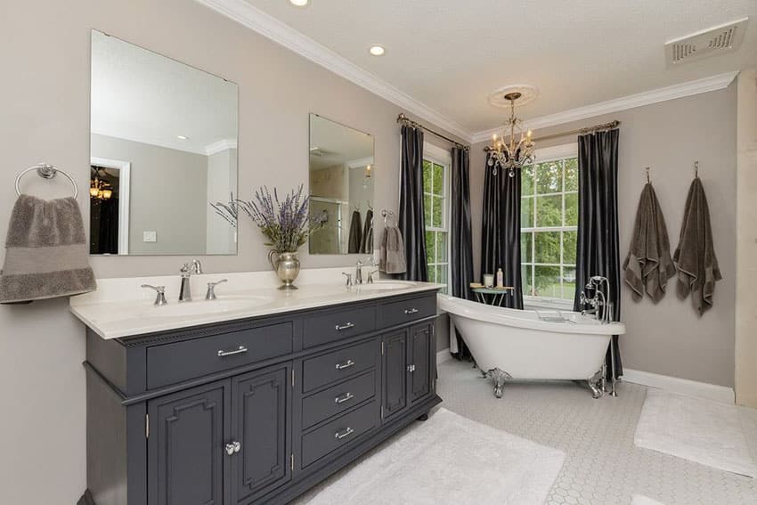 Traditional master bathroom with freestanding clawfoot tub and square field tile