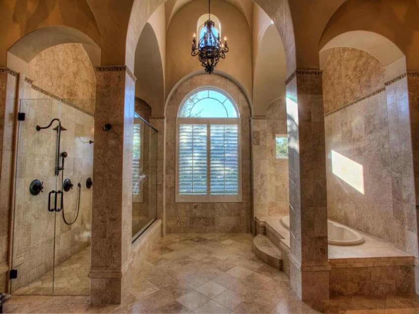 Traditional master bathroom with light brown marble enclosed tub and rain shower with cathedral ceiling