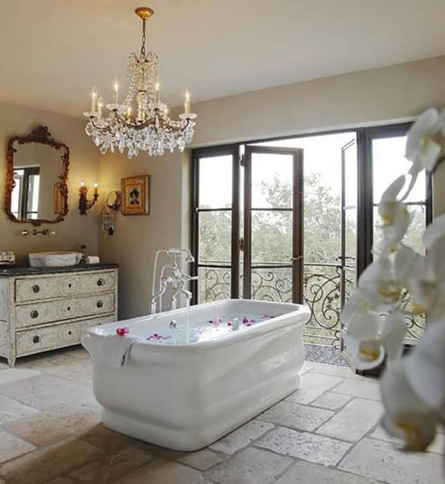 Traditional master bathroom with rectangular bathtub and crystal chandelier