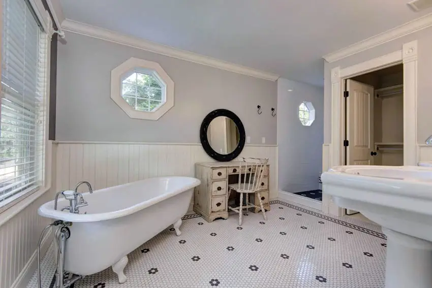 Bathroom with wainscot, white cornice with white penny shape mosaic tiles